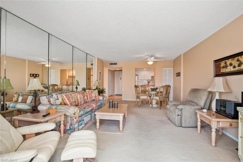 3 Bluebill Avenue, Unit 610 Naples, FL 34108 - Photo 8 of 15 a living room with furniture and a large window