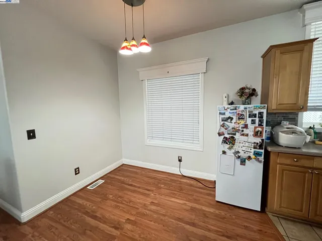 a kitchen with stainless steel appliances granite countertop a refrigerator and a stove
