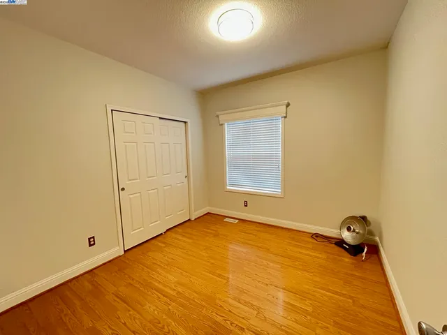 a view of a room with wooden floor and cabinet