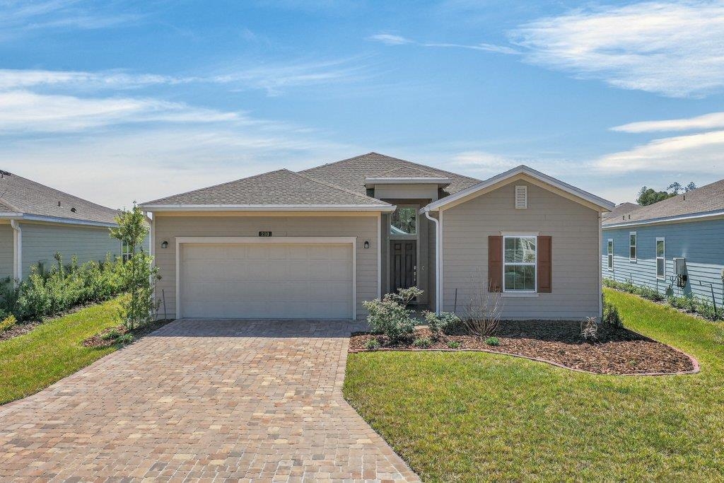 210 White Rabbit Run St. Augustine, FL 32092 - Photo 49 of 85 a front view of a house with a yard and garage