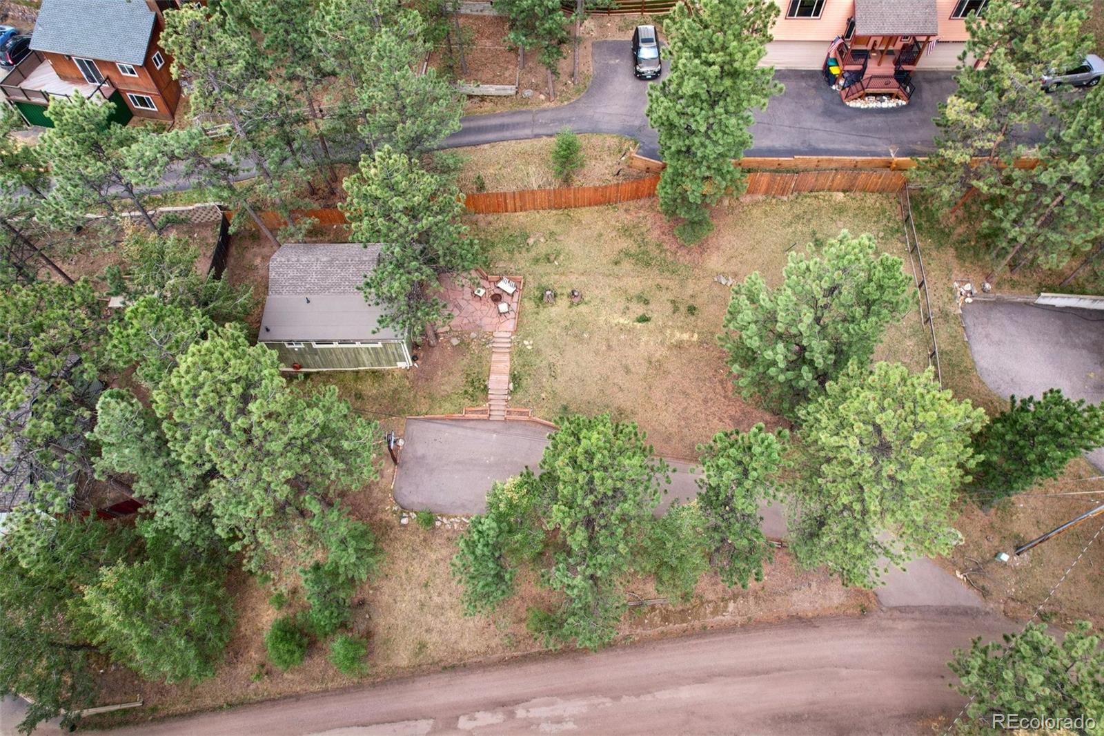 29772 Spruce Road Evergreen, CO 80439 - Photo 6 of 9 an aerial view of a house with garden space and a street view