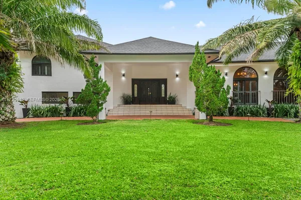 a front view of a house with garden