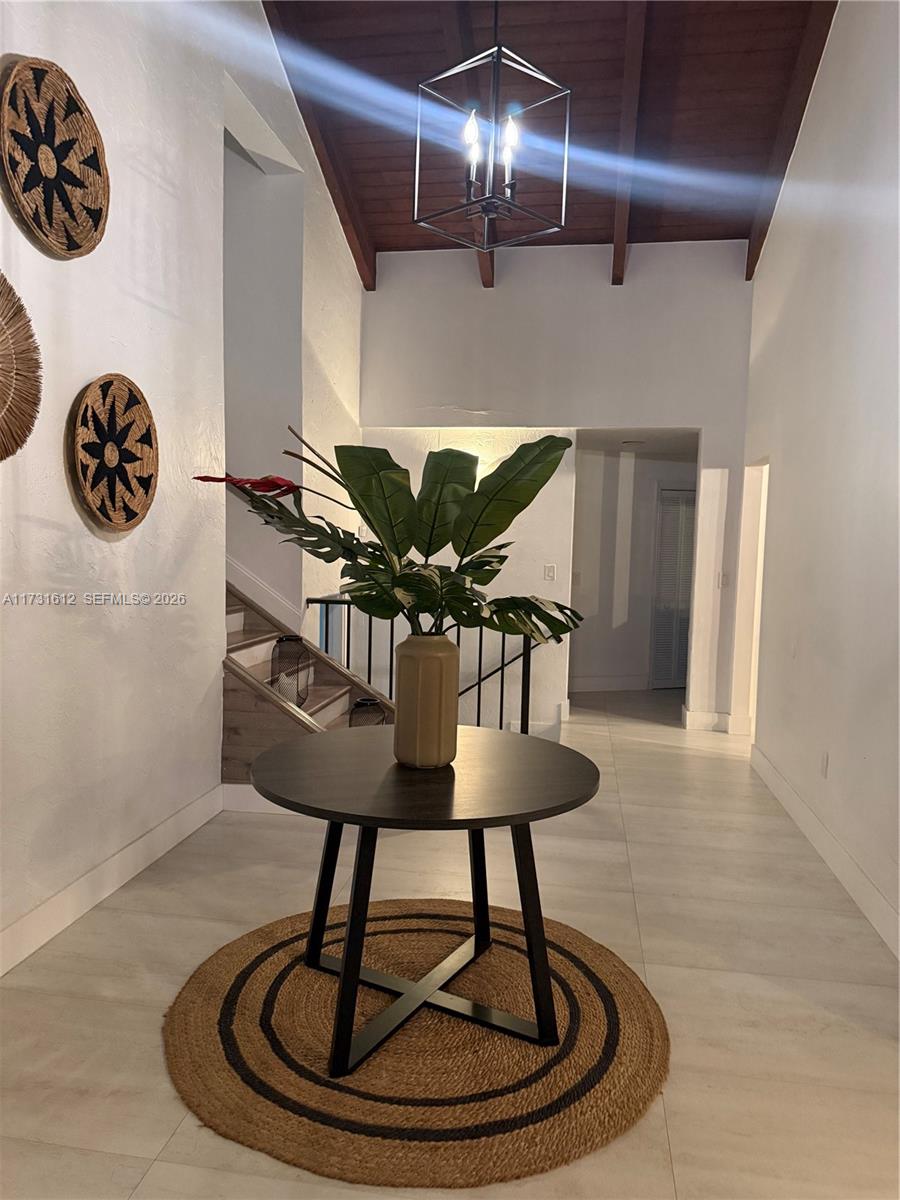 14875 Southwest 212th Street Miami, FL 33187 - Photo 39 of 80 a view of a kitchen with a table and a chandelier