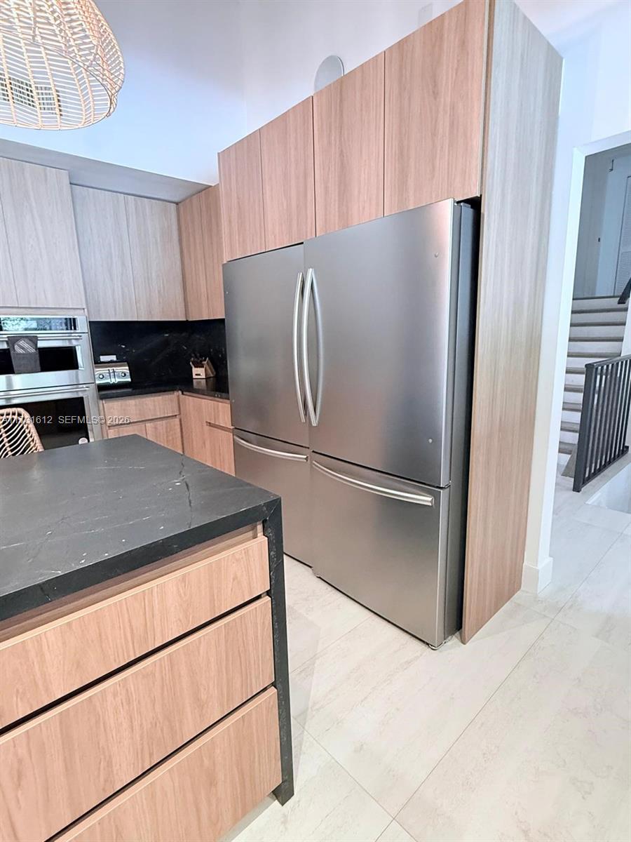 14875 Southwest 212th Street Miami, FL 33187 - Photo 41 of 80 a kitchen with stainless steel appliances a refrigerator sink and cabinets