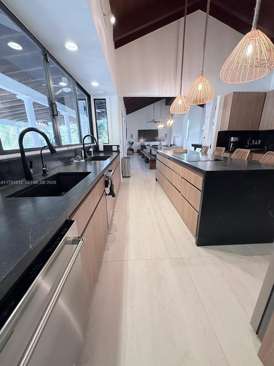 14875 Southwest 212th Street Miami, FL 33187 - Photo 42 of 80 a large kitchen with stainless steel appliances a large counter top a stove and a sink