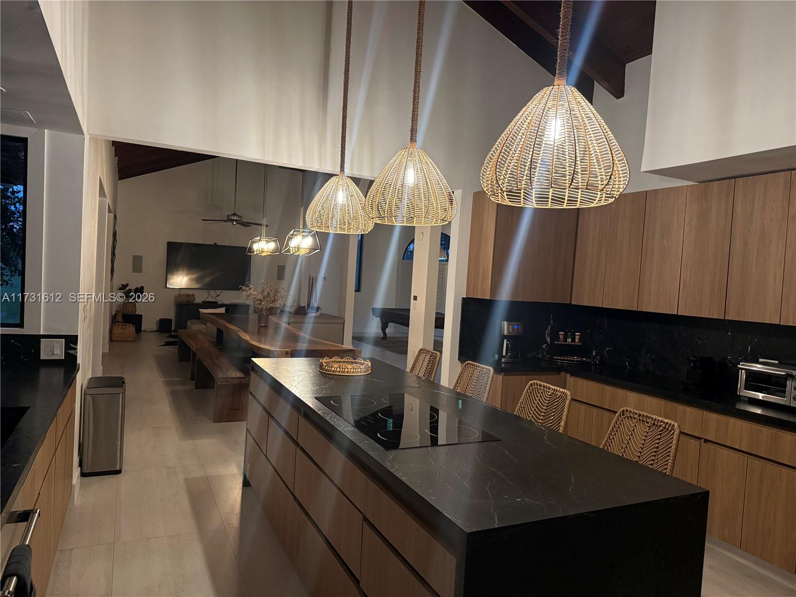 14875 Southwest 212th Street Miami, FL 33187 - Photo 45 of 80 a kitchen with stainless steel appliances granite countertop a sink a stove and a wooden cabinets