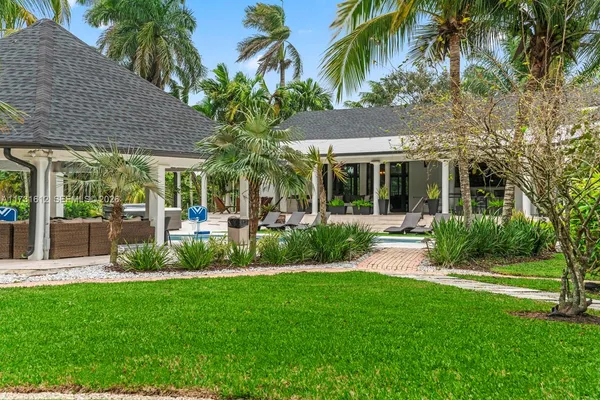 a view of swimming pool with outdoor seating and a garden