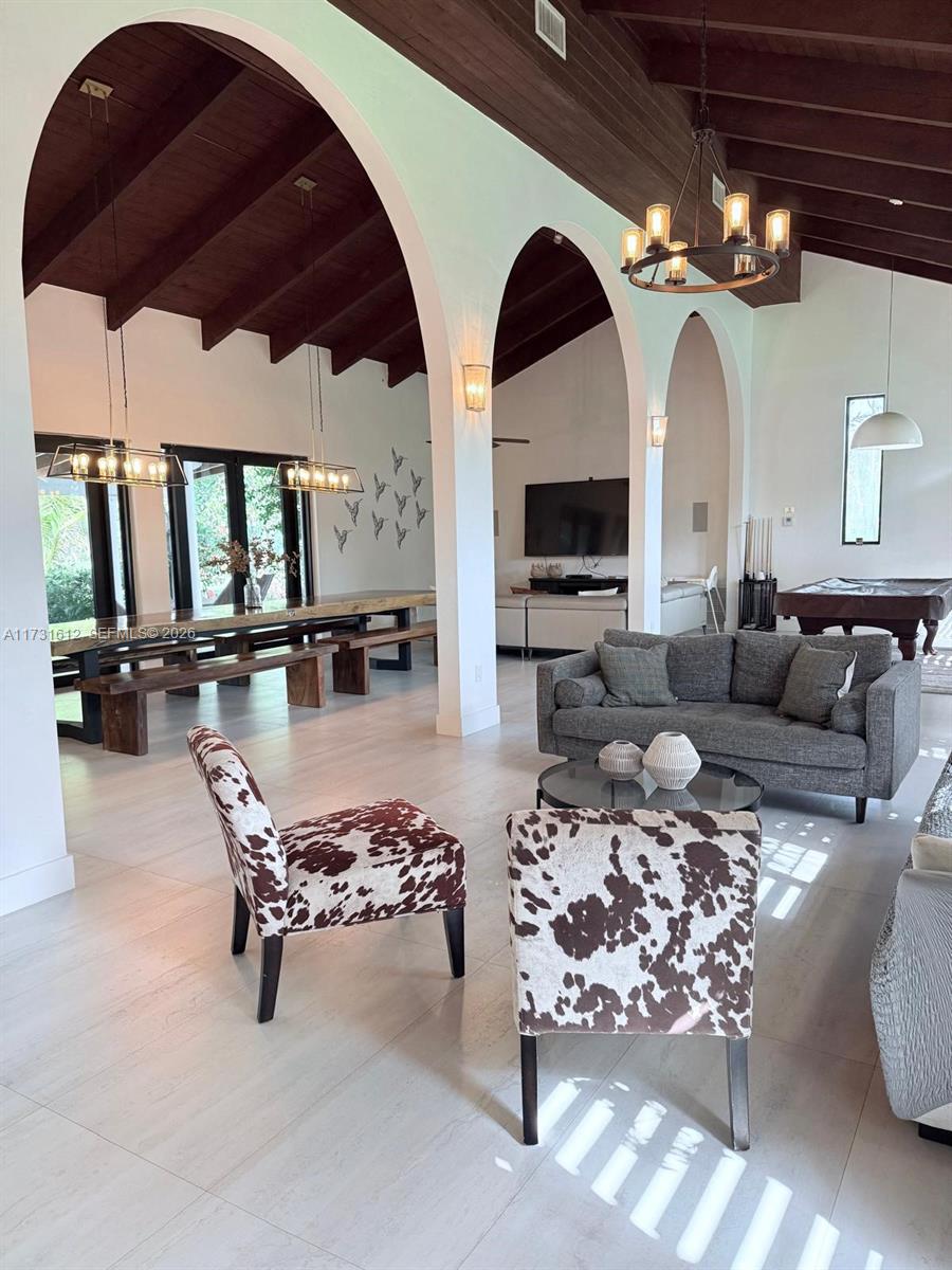 14875 Southwest 212th Street Miami, FL 33187 - Photo 52 of 80 a living room with patio furniture and a large mirror