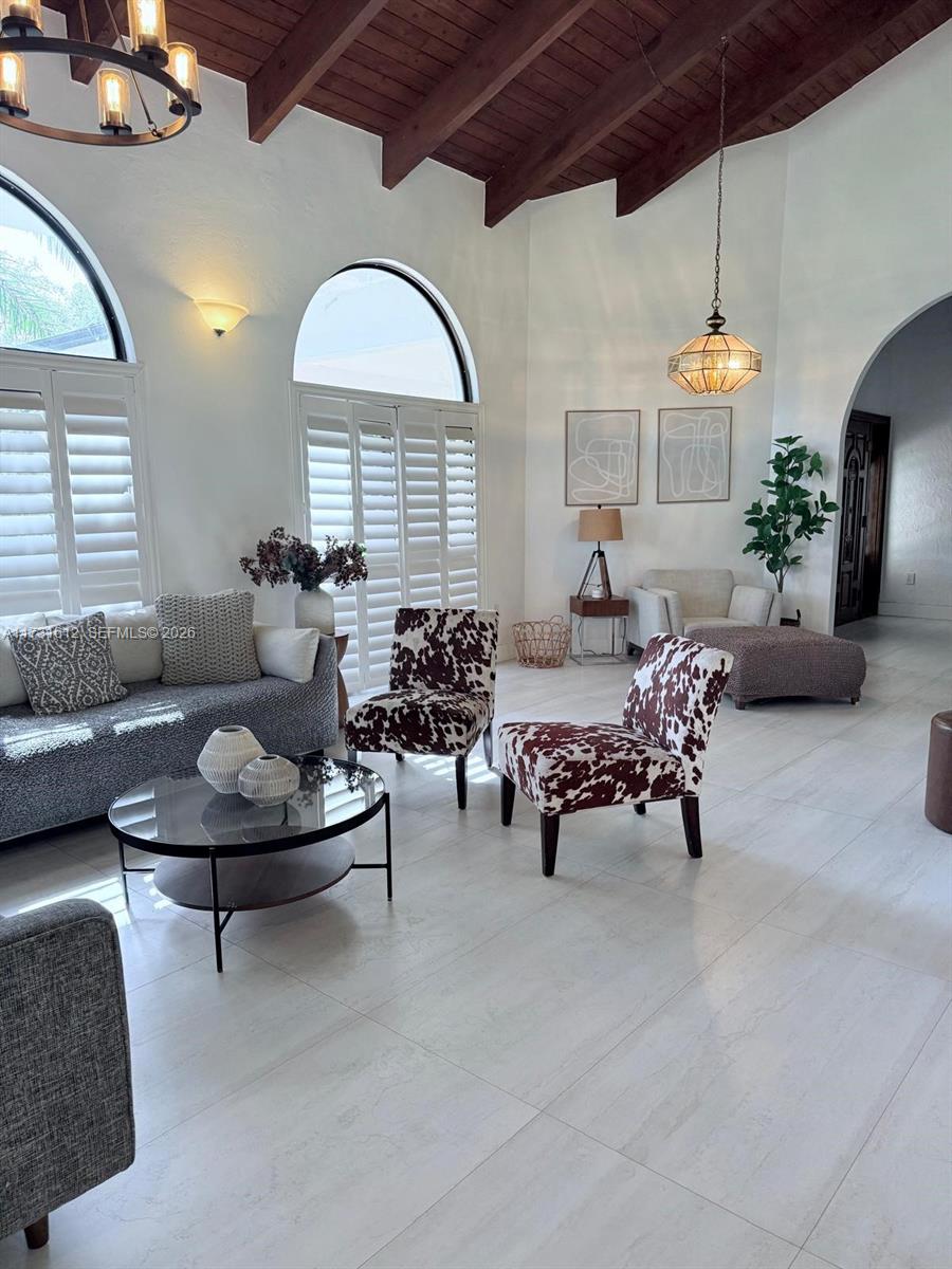 14875 Southwest 212th Street Miami, FL 33187 - Photo 56 of 80 a living room with furniture and a chandelier
