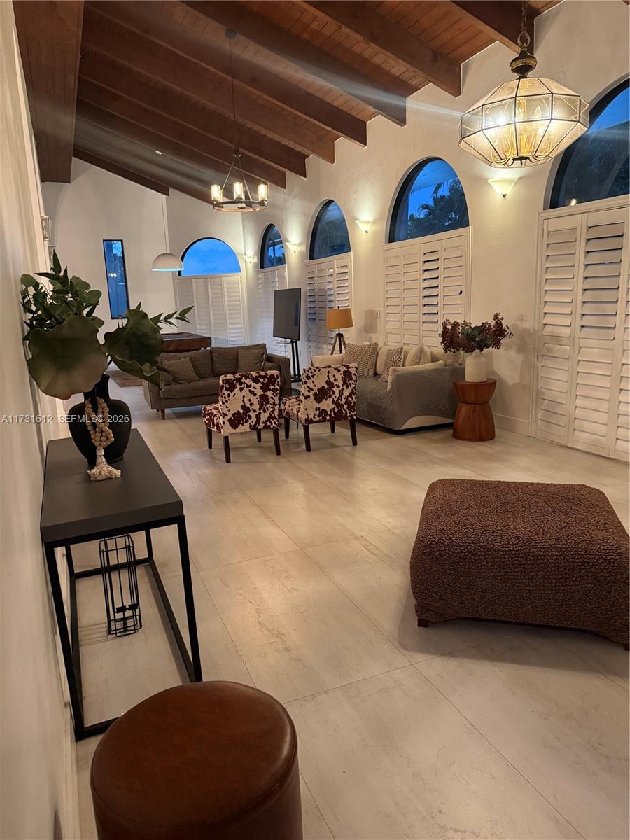 14875 Southwest 212th Street Miami, FL 33187 - Photo 60 of 80 a living room with furniture a fireplace and a chandelier