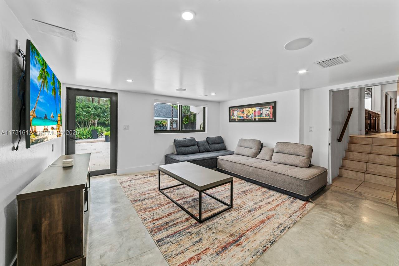 14875 Southwest 212th Street Miami, FL 33187 - Photo 63 of 80 a living room with furniture and a flat screen tv