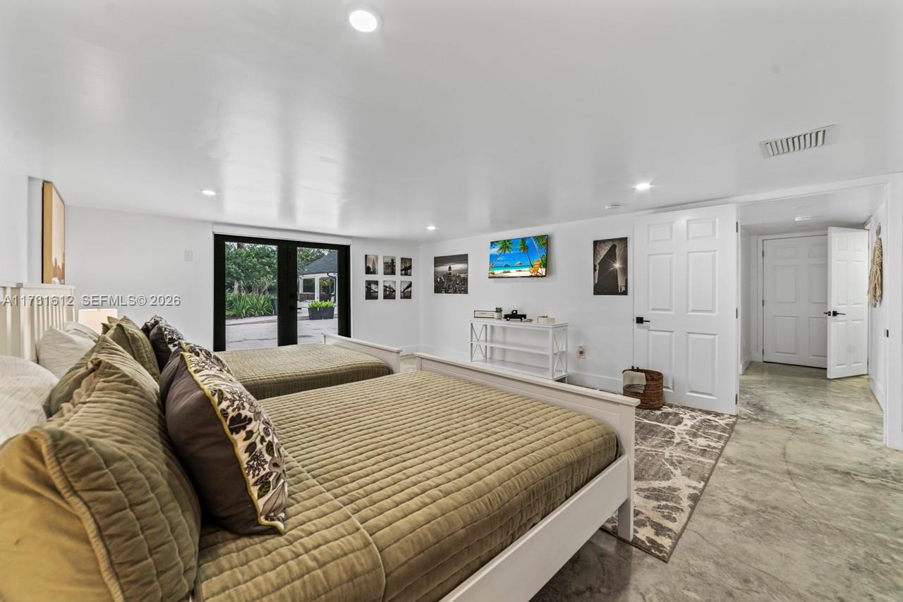 14875 Southwest 212th Street Miami, FL 33187 - Photo 65 of 80 a spacious bedroom with a bed and a large window