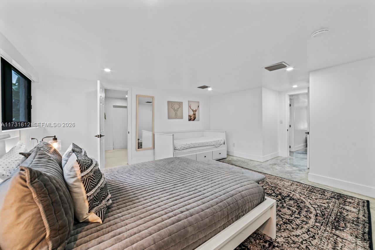 14875 Southwest 212th Street Miami, FL 33187 - Photo 67 of 80 a bedroom with a bed and a couch
