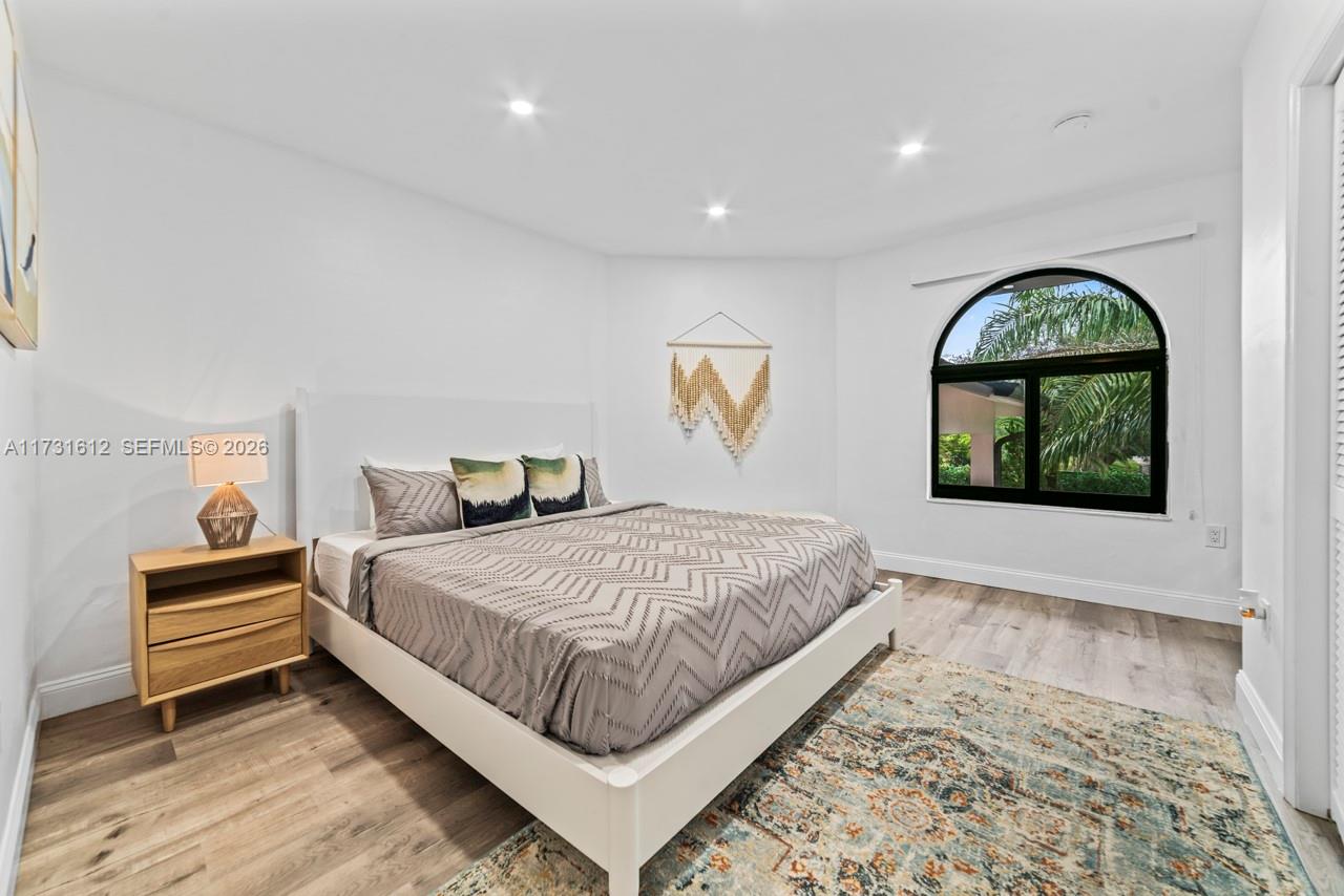 14875 Southwest 212th Street Miami, FL 33187 - Photo 77 of 80 a bedroom with a bed and a painting on the wall