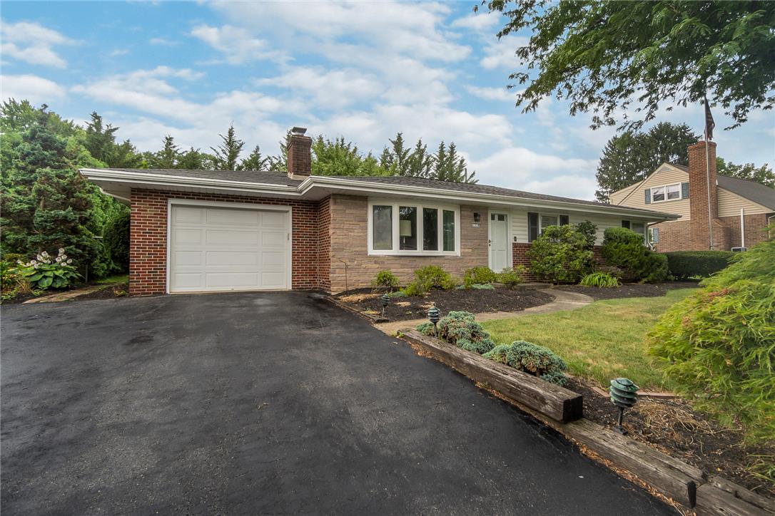 1328 Russett Road Allentown, PA 18104 - Photo 2 of 46 A well-maintained single-story home with an attached garage and a maturely landscaped yard.