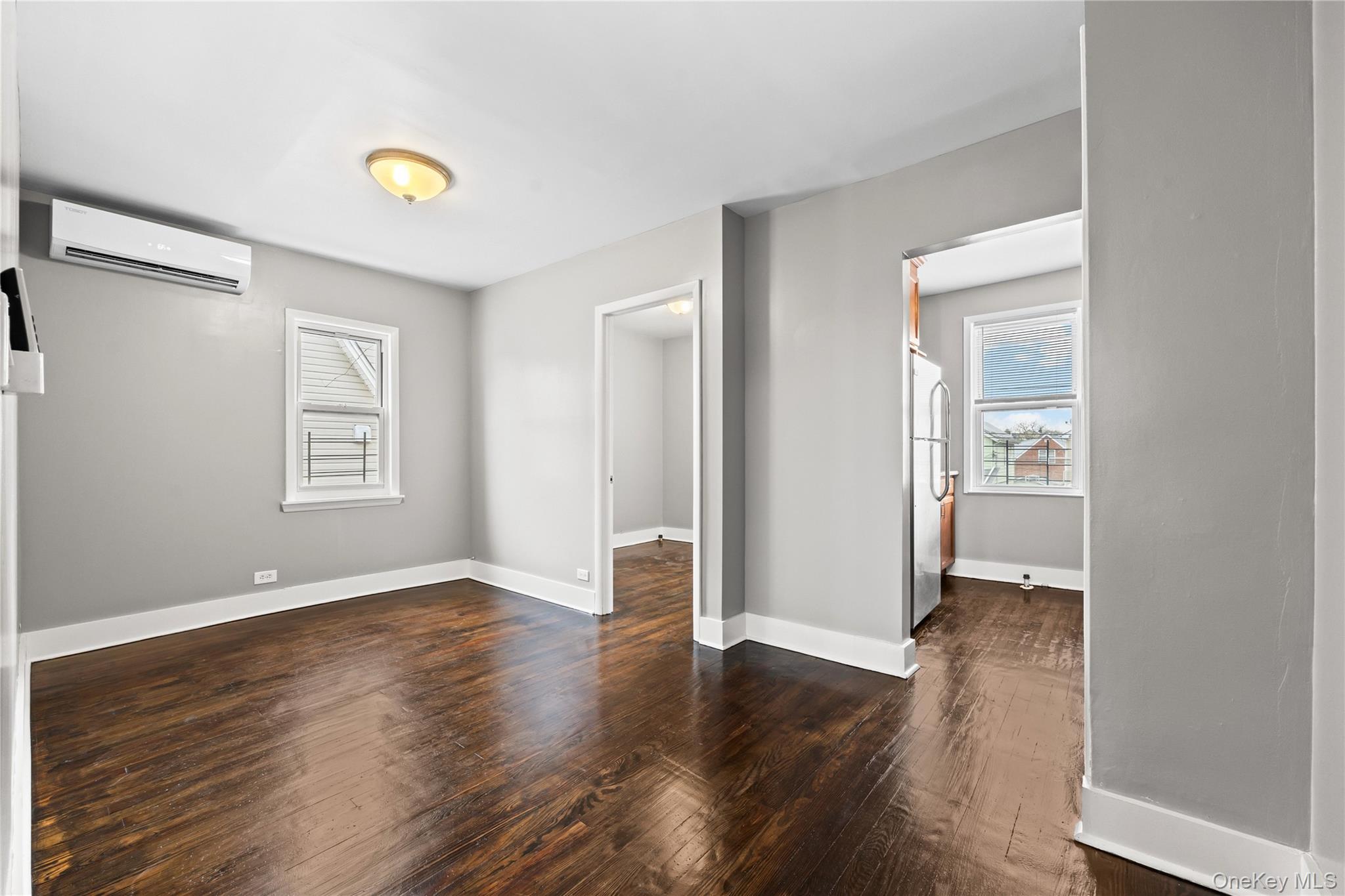 42-25 189th Street Queens, NY 11358 - Photo 15 of 25 an empty room with wooden floor and windows