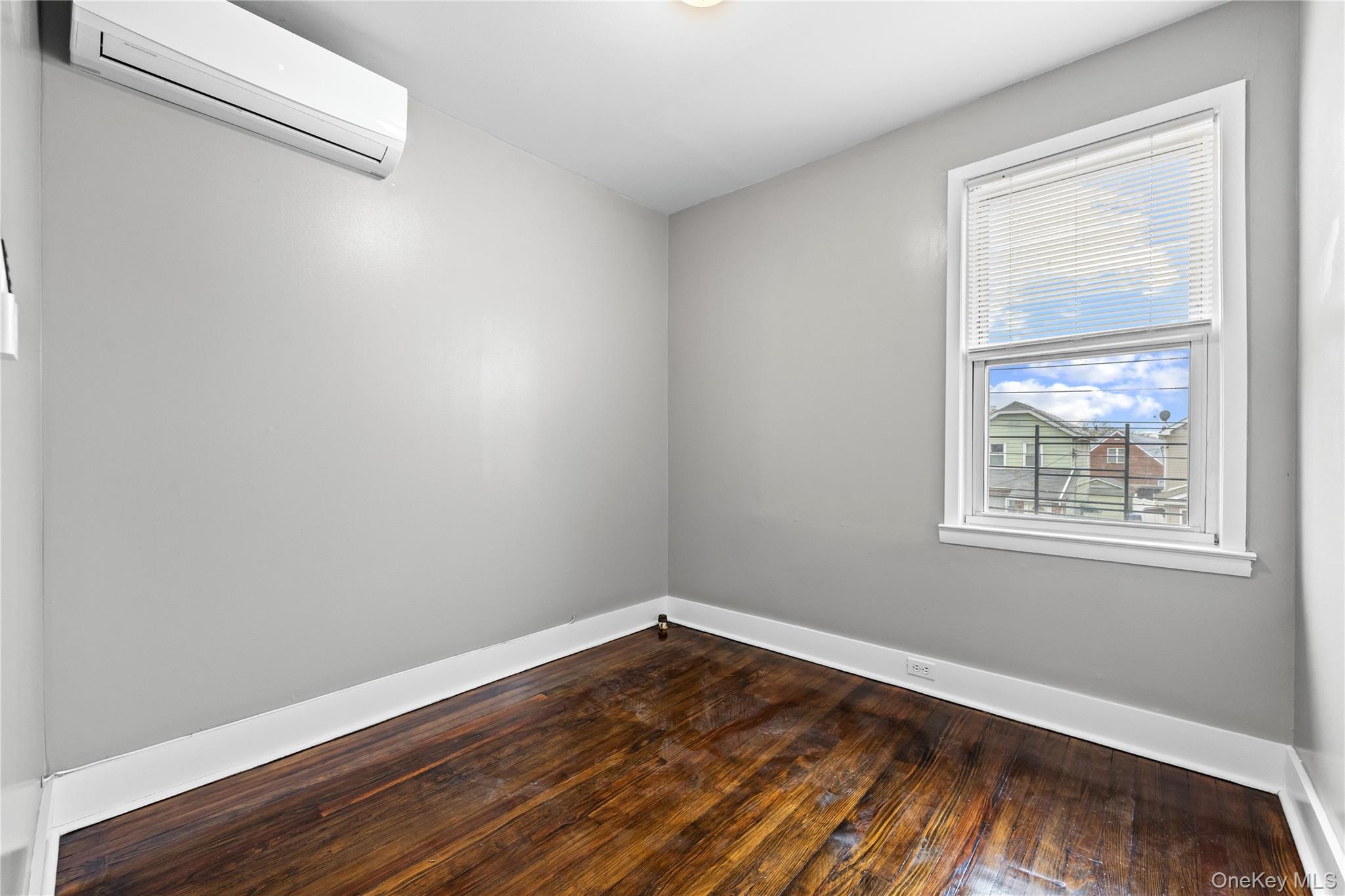 42-25 189th Street Queens, NY 11358 - Photo 16 of 25 a view of an empty room and wooden floor