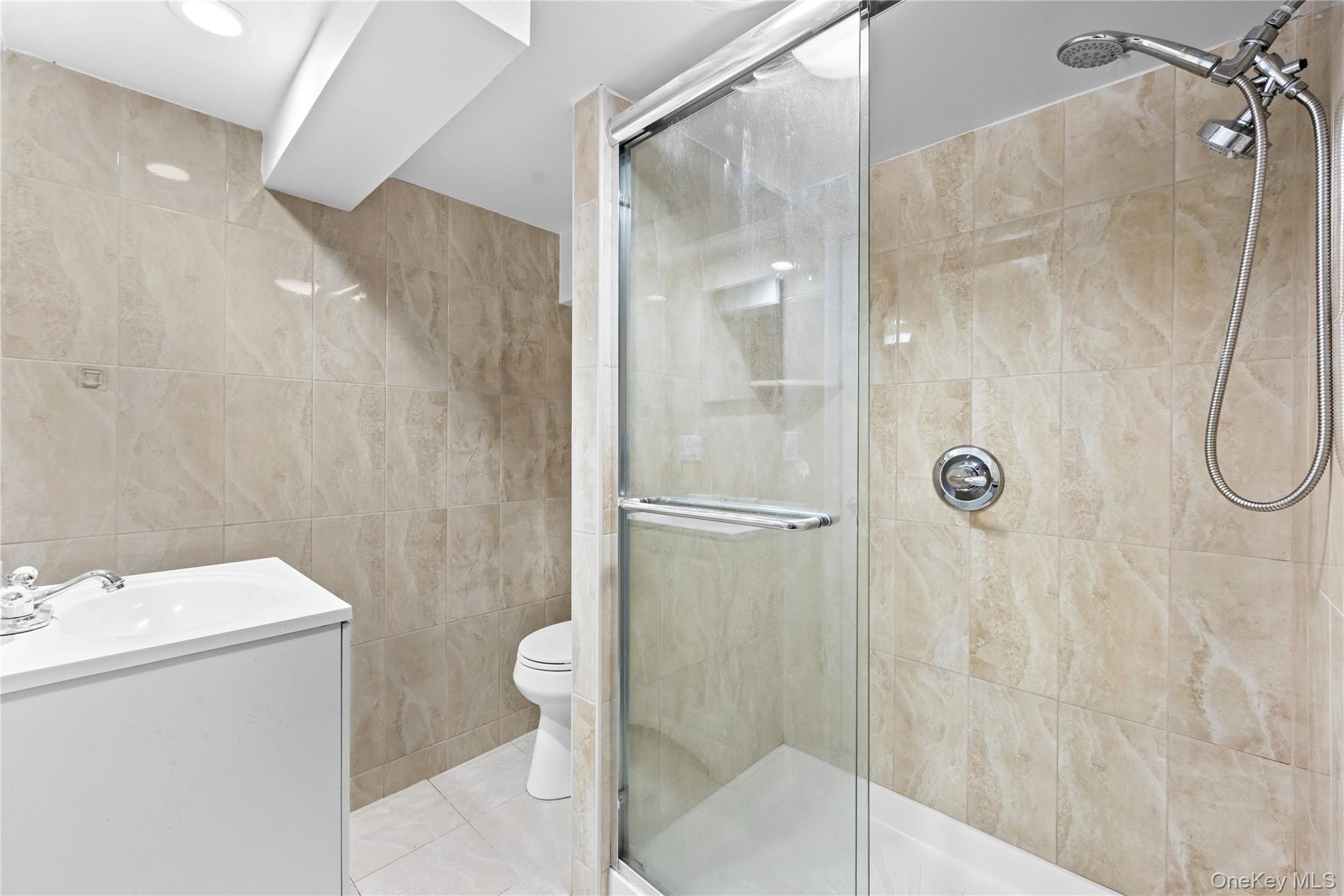 42-25 189th Street Queens, NY 11358 - Photo 23 of 25 a bathroom with a shower and sink