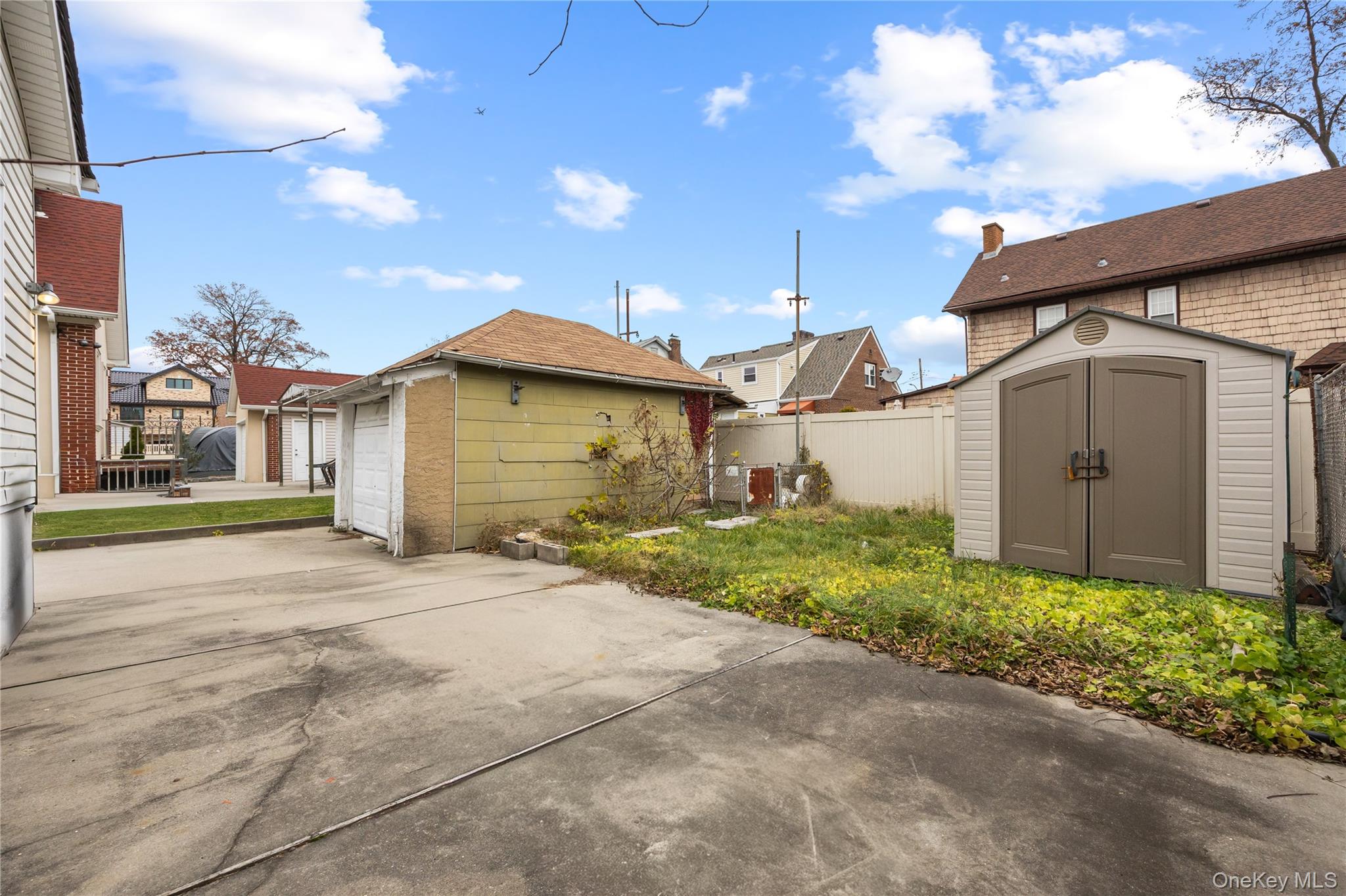 42-25 189th Street Queens, NY 11358 - Photo 25 of 25 a front view of a house with a yard and garage
