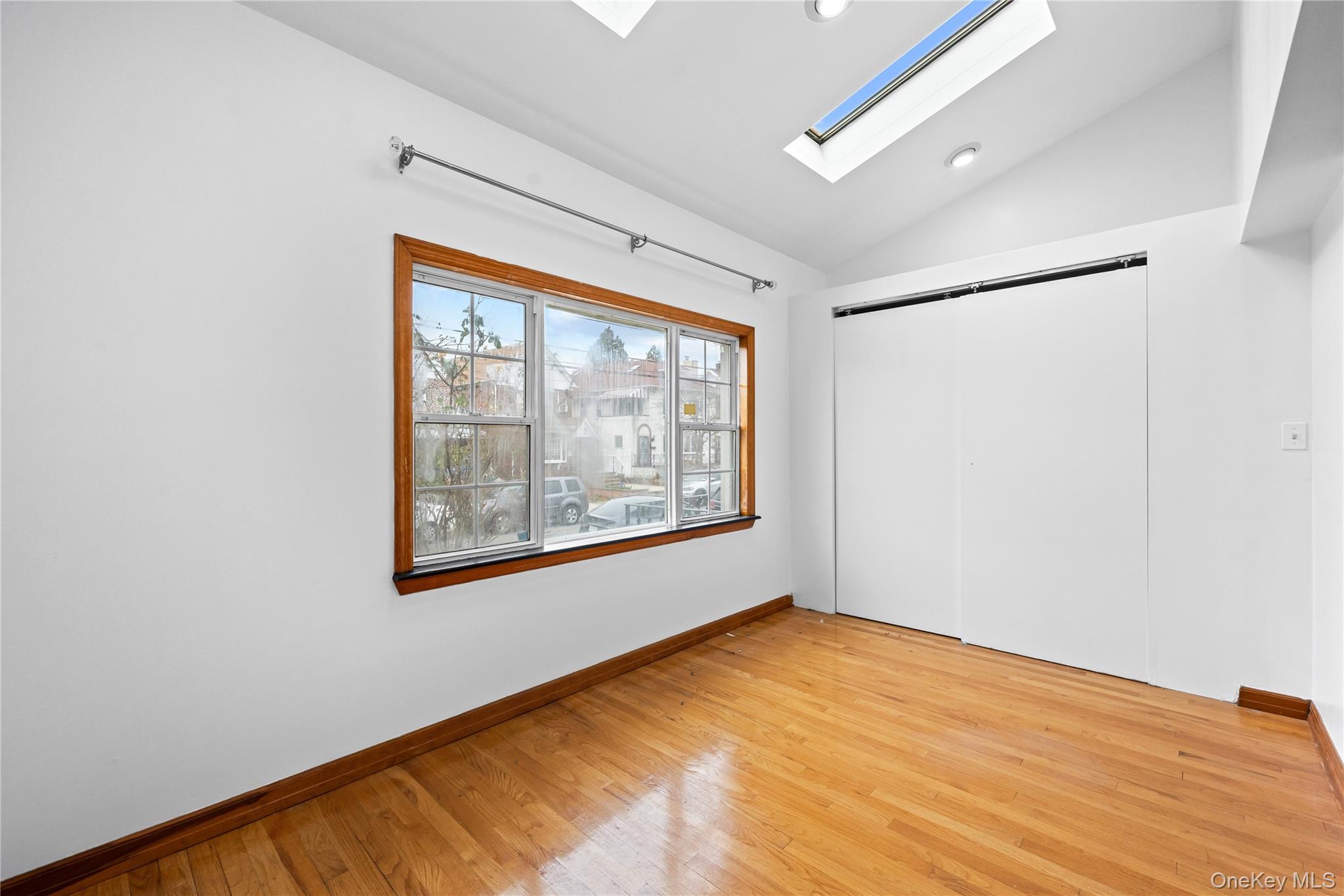 42-25 189th Street Queens, NY 11358 - Photo 6 of 25 a view of an empty room with a window