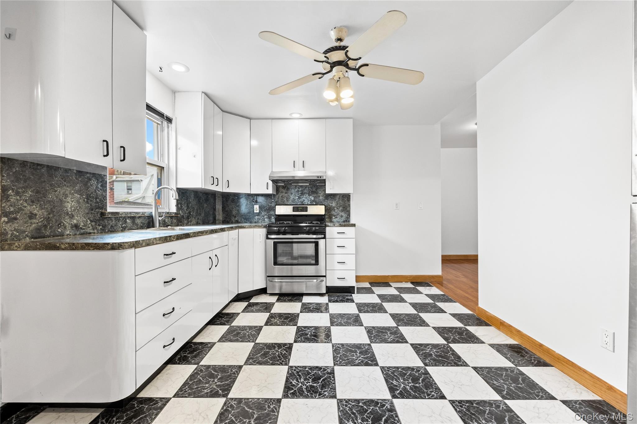 42-25 189th Street Queens, NY 11358 - Photo 7 of 25 a kitchen with stainless steel appliances and cabinets