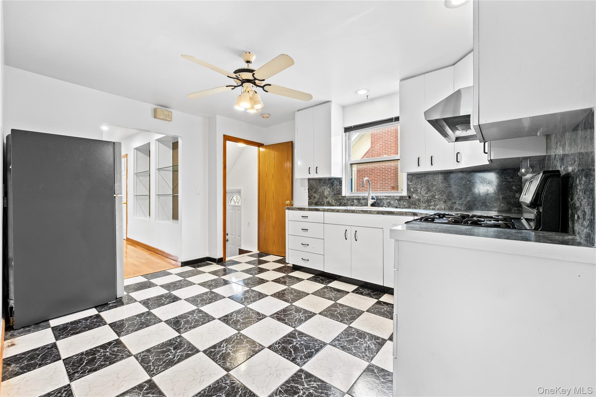 42-25 189th Street Queens, NY 11358 - Photo 8 of 25 a kitchen with stainless steel appliances granite countertop a sink stove and refrigerator