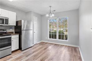 3882 Waldrop Lane Decatur, GA 30034 - Photo 2 of 11 a view of a kitchen with wooden floor electronic appliances and window