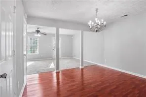 a view of a chandelier fan and wooden floor