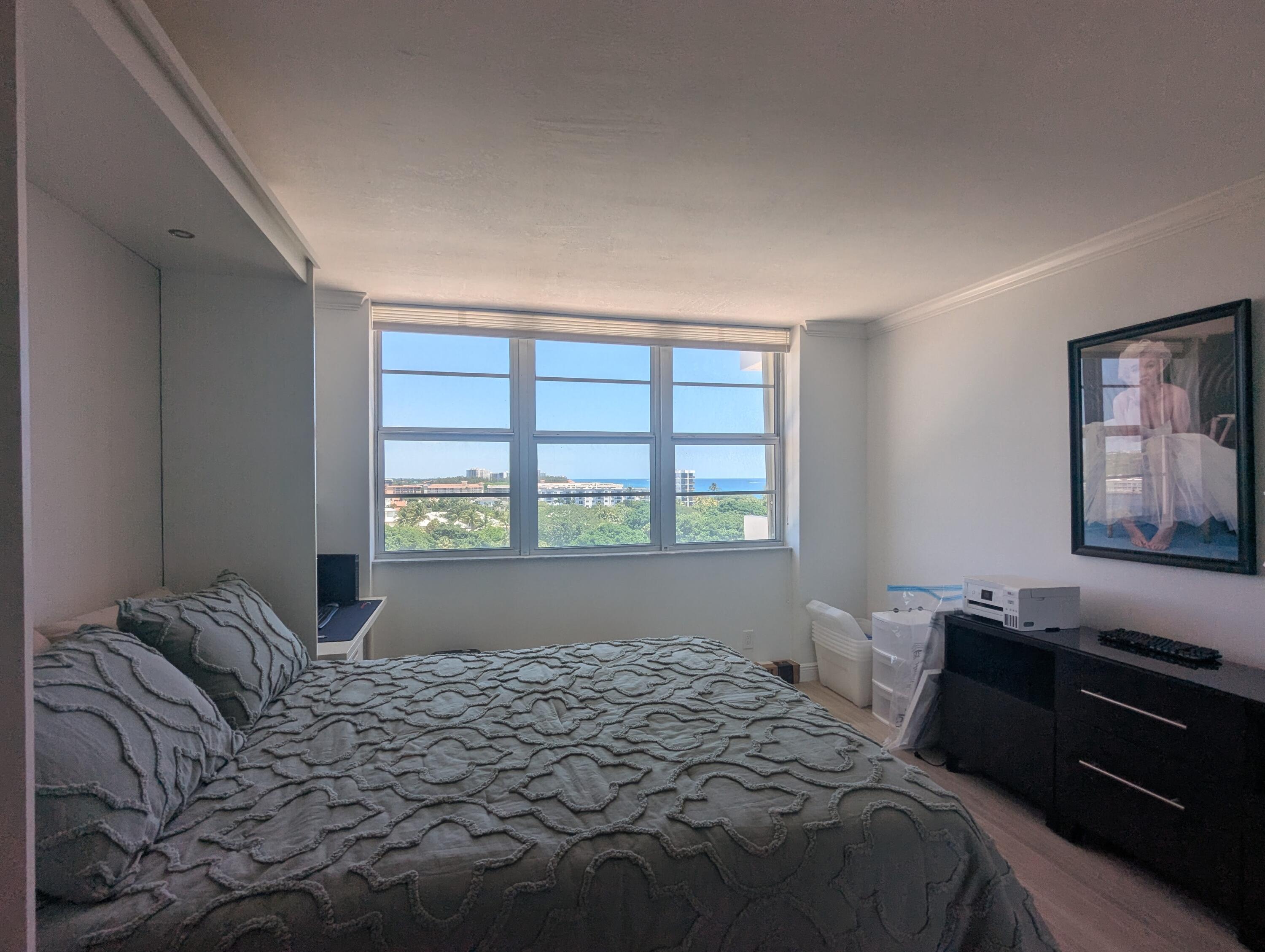 2121 North Ocean Boulevard, Unit 1006E Boca Raton, FL 33431 - Photo 40 of 64 a bedroom with a bed and a window