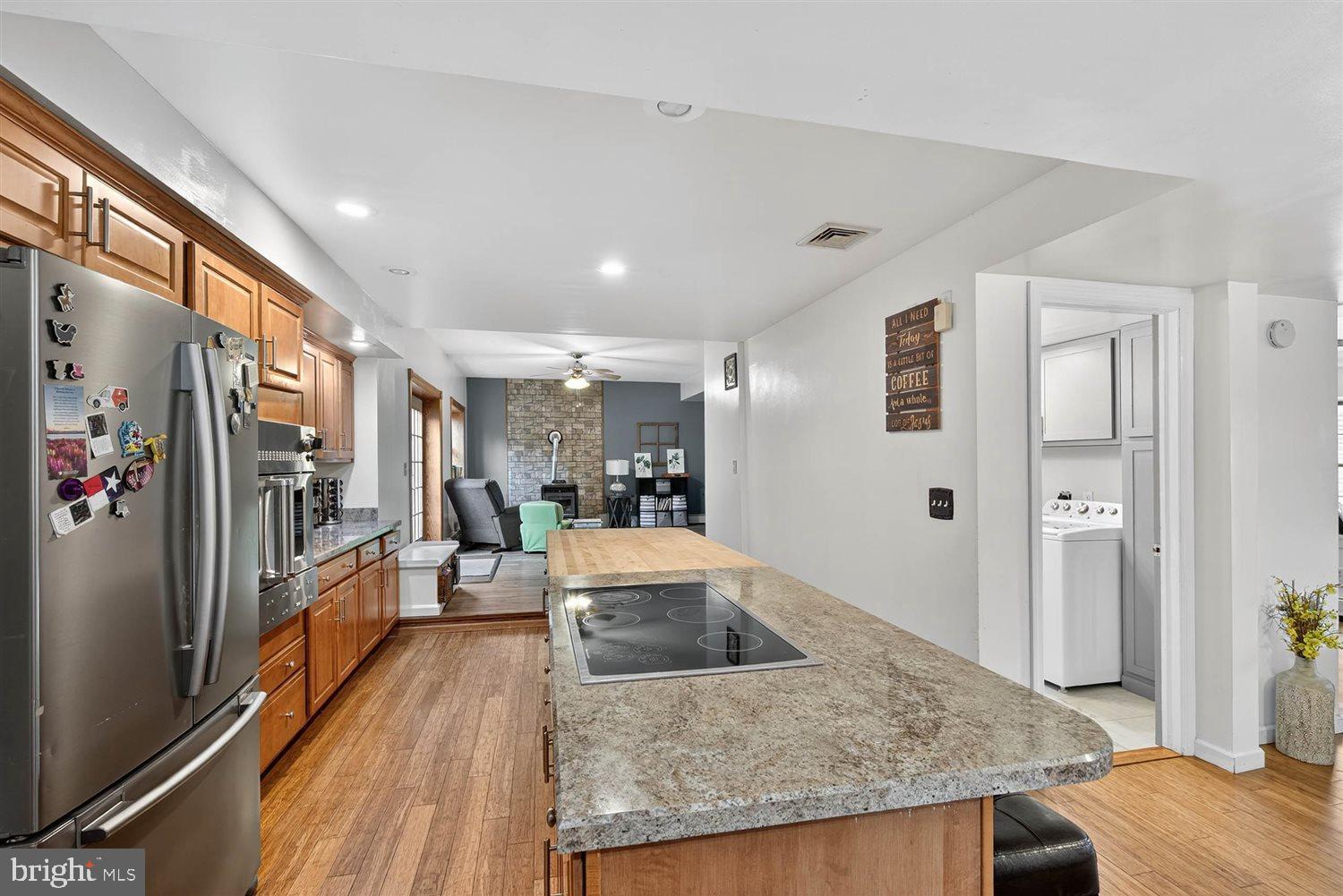 5987 River Road Conestoga, PA 17516 - Photo 16 of 40 a living room with stainless steel appliances granite countertop furniture and a wooden floor