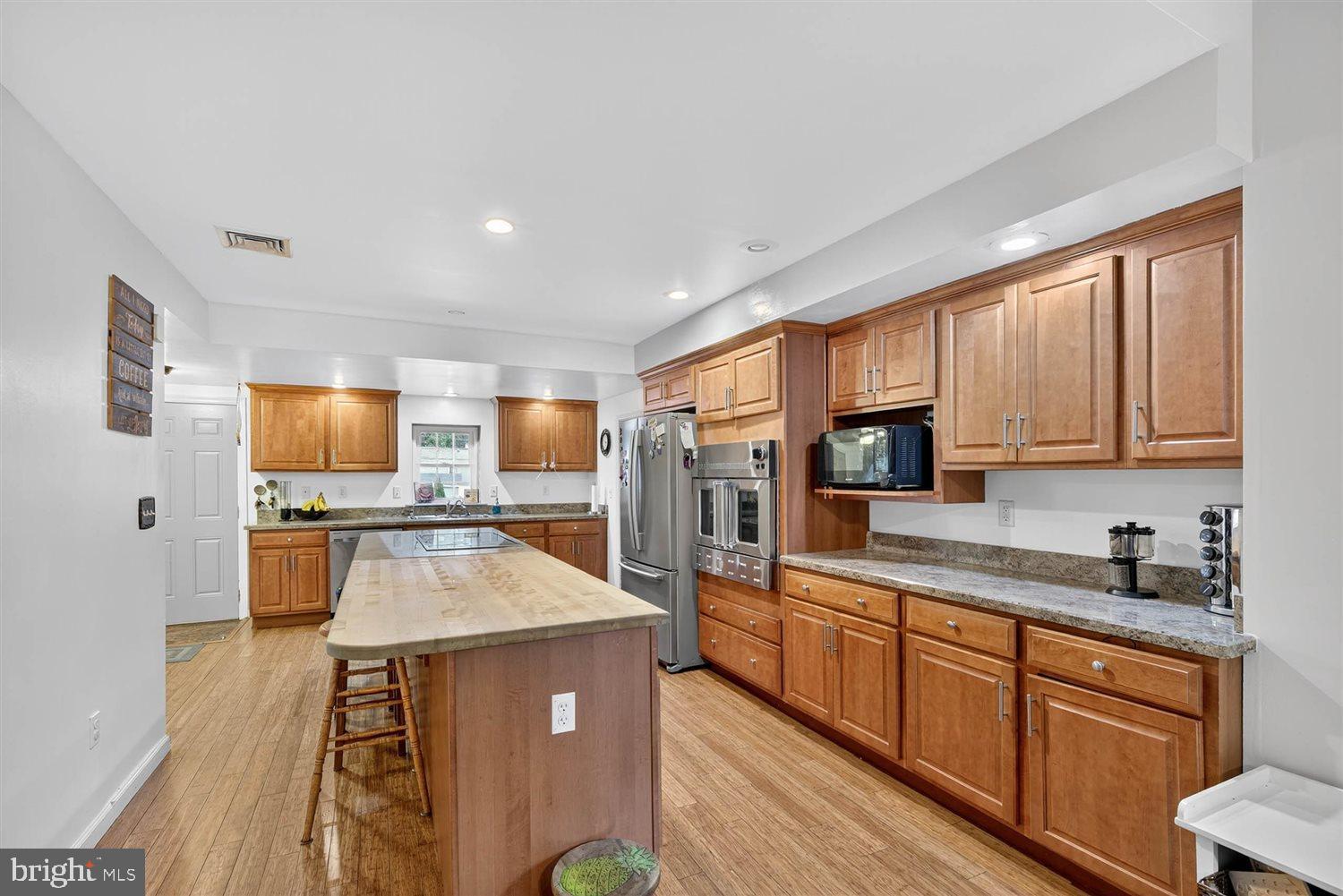 5987 River Road Conestoga, PA 17516 - Photo 4 of 40 a large kitchen with a large window and stainless steel appliances