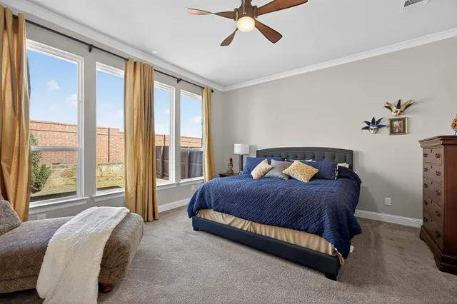 a spacious bedroom with a bed and large window