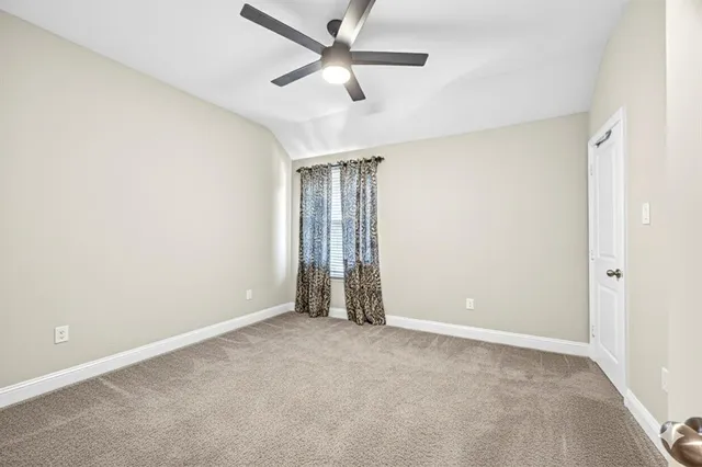 an empty room with closet and windows