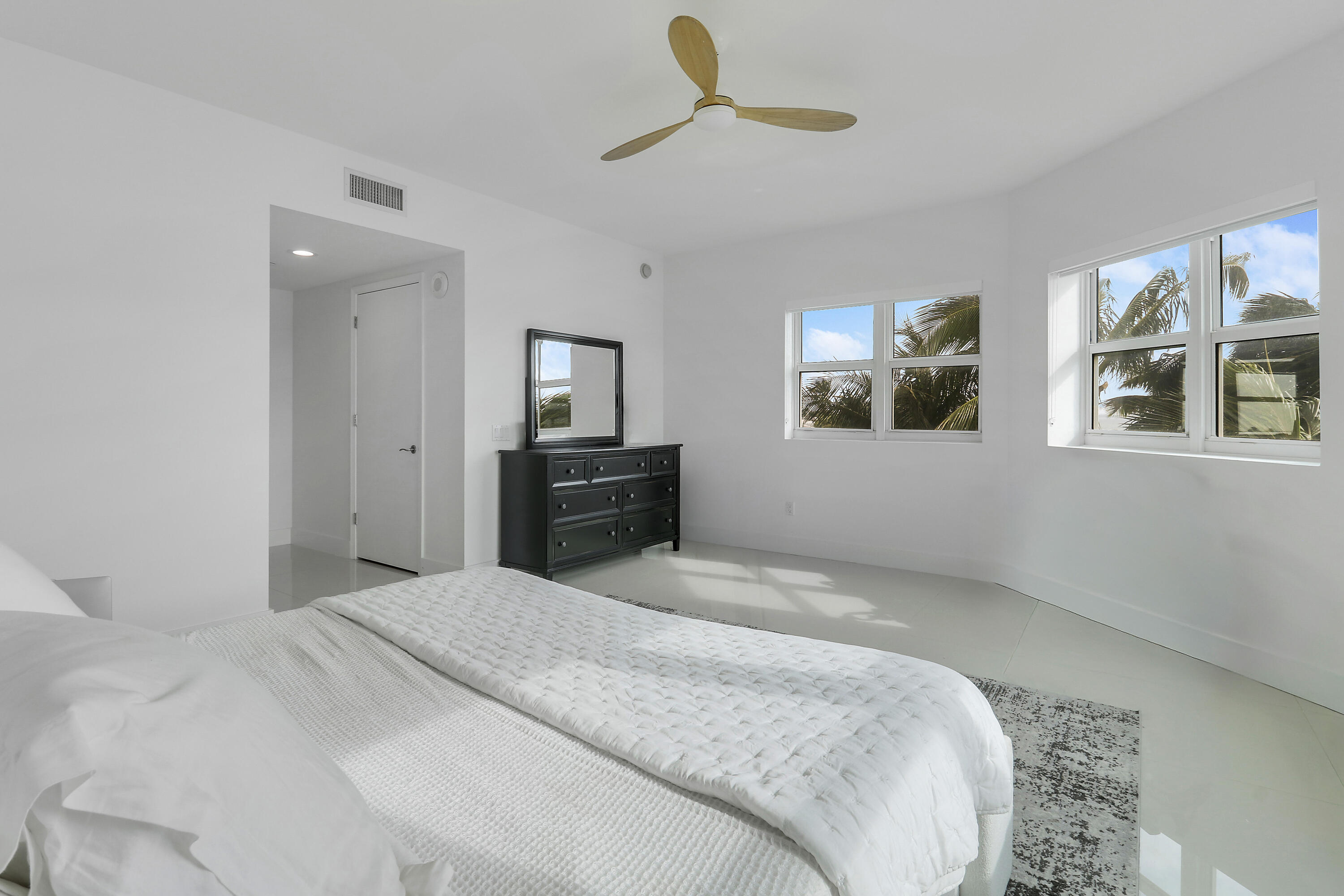 2640 Lake Shore Drive, Unit 307 Riviera Beach, FL 33404 - Photo 30 of 44 a bedroom with a bed and a chandelier