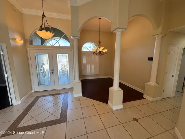 a view of a room with wooden floor window and a chandelier