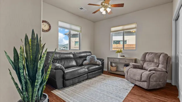 a living room with furniture a chandelier and a window
