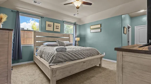 a bedroom with a bed and a chandelier