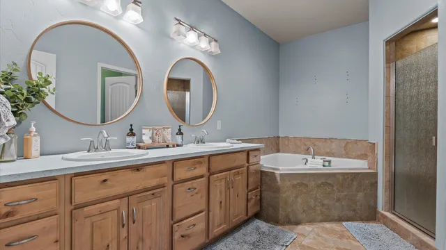 a bathroom with a double vanity sink and a mirror