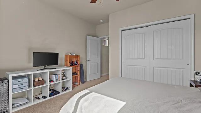 a bedroom with a bed and a flat screen tv