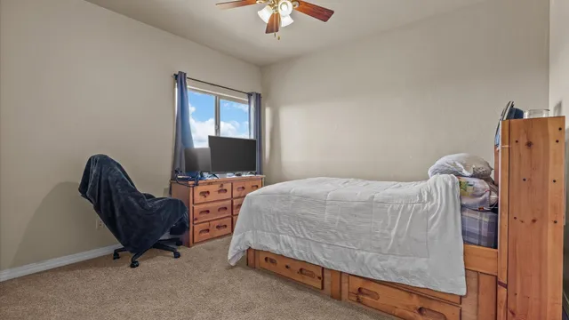 a bedroom with a bed and a chandelier