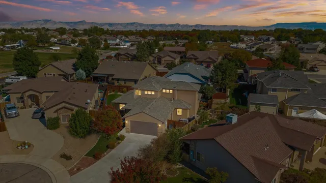 an aerial view of a house with a mountain