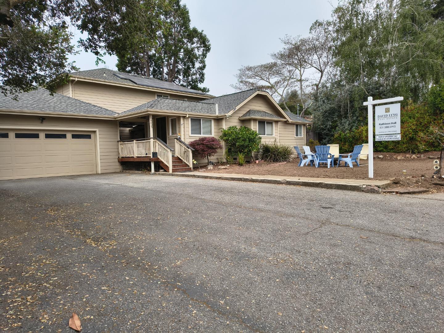 a view of a house with large space and a car parked beside of it