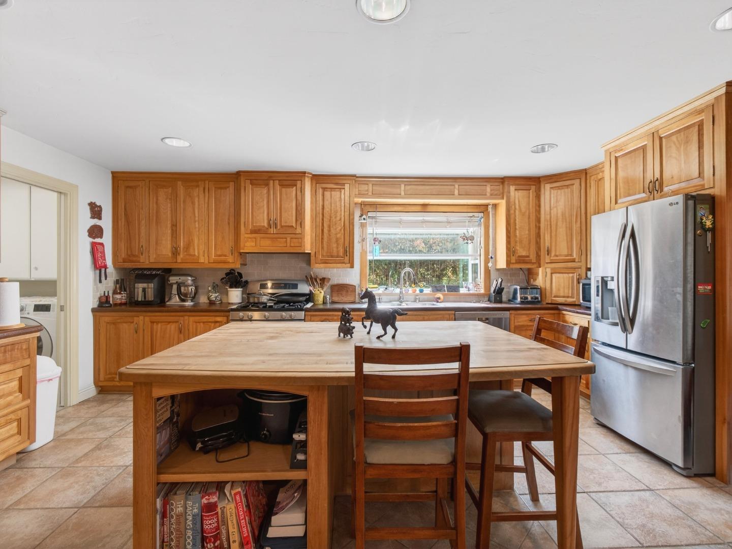 209 Hames Road Watsonville, CA 95076 - Photo 19 of 60 a kitchen with a refrigerator a stove a sink and a dining table