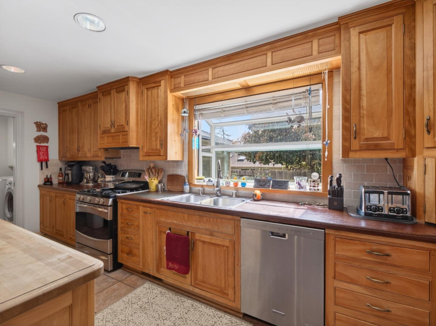 209 Hames Road Watsonville, CA 95076 - Photo 20 of 60 a kitchen with stainless steel appliances granite countertop wooden cabinets a stove a sink and dishwasher