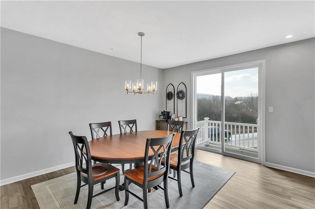 107 Affinity Drive Harmony, PA 16037 - Photo 11 of 49 a view of a dining room with furniture window and wooden floor