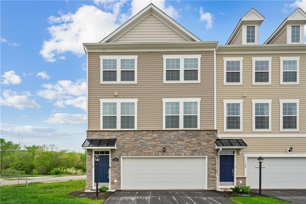 107 Affinity Drive Harmony, PA 16037 - Photo 2 of 49 a front view of a house with a yard and garage