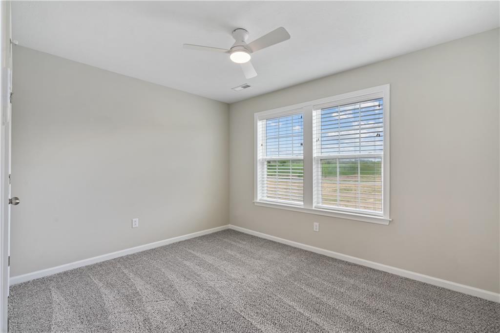 107 Affinity Drive Harmony, PA 16037 - Photo 24 of 49 an empty room with a window and a ceiling fan