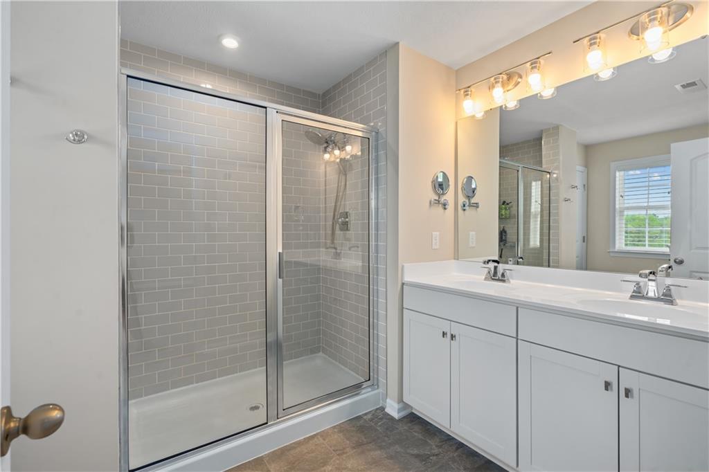 107 Affinity Drive Harmony, PA 16037 - Photo 33 of 49 a bathroom with a shower sink and mirror
