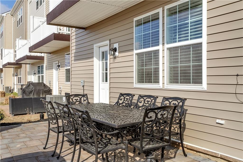 107 Affinity Drive Harmony, PA 16037 - Photo 4 of 49 a view of a patio with table and chairs and wooden floor