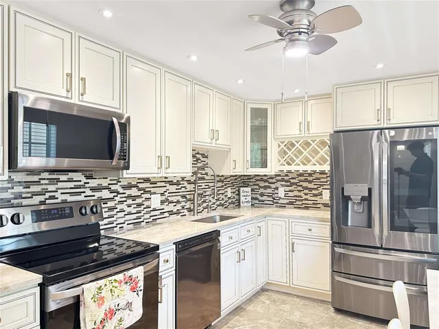 a kitchen with stainless steel appliances a stove microwave and refrigerator